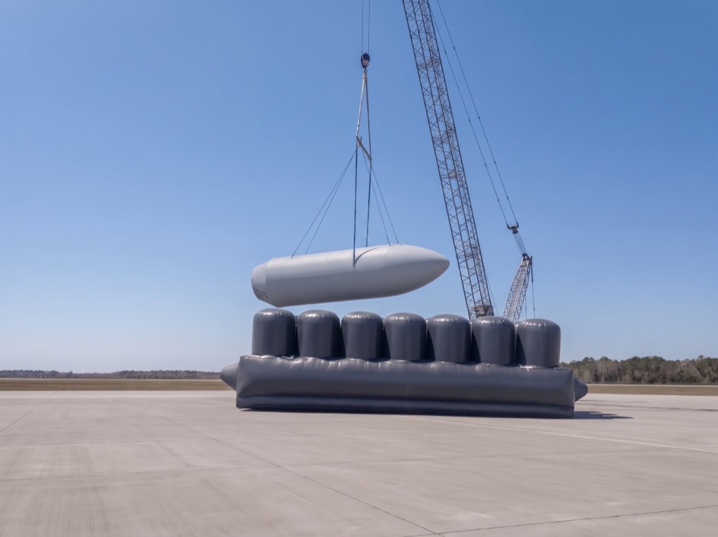 Custom multi-chamber air-cushion catch-bag system positioned to receive aerospace hardware during a test operation
